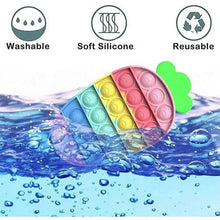 Round pop it fidget toy in pastel colors partially submerged in water