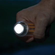 Rechargeable camping lantern flashlight mode in hand, bright beam from round lens
