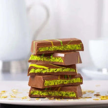 Stacked milk chocolate bars with green pistachio filling and crispy kadaif layers.