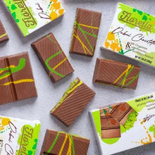Assorted milk chocolate bars with pistachio filling and striped nut topping.