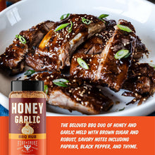 Honey garlic BBQ rub bottle beside grilled chicken wings topped with herbs