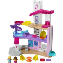 Three-story dollhouse playset with purple and pink accents and small accessory pieces