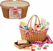 Woven wicker picnic basket with checkered liner and wooden pretend food pieces