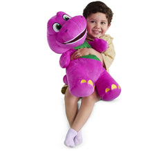Purple plush dinosaur with green belly, hugged by a child in front view