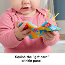 Colorful crinkle panel baby toy with buttons, held for play