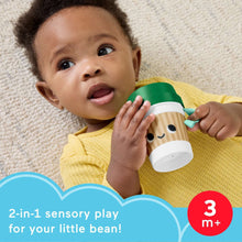 Baby exploring Fisher-Price mini coffee cup teether with green lid and face design
