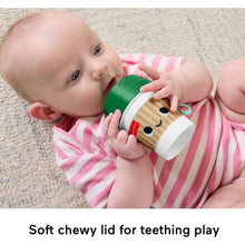 Baby holding Fisher-Price mini coffee cup teether with soft chew lid