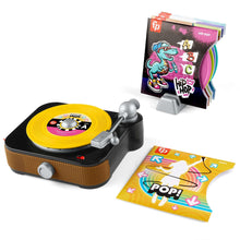 Toddler record player toy with yellow turntable record, silver arm, and record sleeves