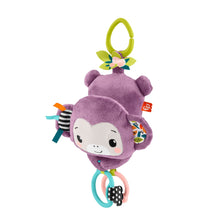 Purple monkey plush sensory toy with smiling face, green flower top, and hanging ring