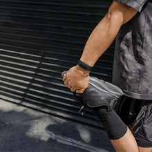Fitbit Charge 6 fitness watch on wrist, black silicone band with dark display