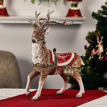 Deer figurine standing on red base, brown antlers, red saddle with green trim and gold accents