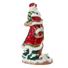 Three-quarter view Santa figurine in red robe with green trim and lantern