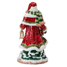 Back view Santa figurine in red robe with green trim and lantern accessory
