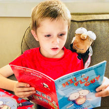 Fly Guy plush and hardcover books held open by child
