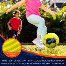 Soft foam soccer ball in bright yellow with black panels, held near a child