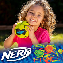 Child holding a bright yellow soft foam soccer ball with black panels and Nerf logo