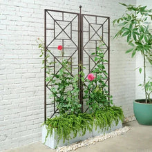 Foldable metal trellis with X-lattice panels and dense green climbing plants