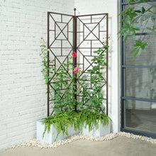 Foldable metal trellis with X-lattice panels and climbing green plants with pink flowers