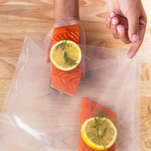 Vacuum-sealed bag holding a salmon portion with lemon slice