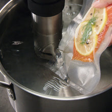 Vacuum sealer bag with food inside a FoodSaver vacuum chamber