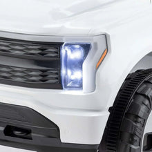 Close-up of white Ford ride-on truck headlight with black grille surround