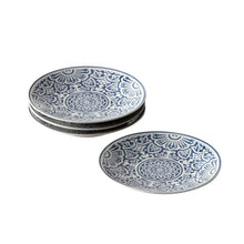 Stacked blue patterned dinner plates with circular floral medallion