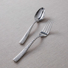 Faceted flatware spoon and fork with textured silver handles, polished bowls