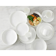 White ceramic dinnerware set with assorted bowls and cups, arranged