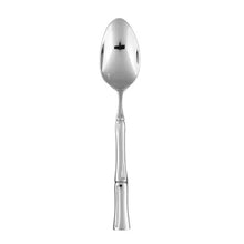 Stainless serving spoon with teardrop bowl and bamboo-style handle