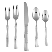 Assorted stainless flatware pieces: forks, knife, and spoons with polished finish