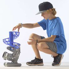 Baseball pitching machine with blue ball basket and gray base, angled for feeding