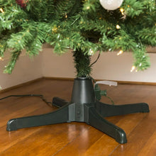 Dark green Christmas tree stand base with central hub and four arms holding tree
