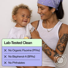 Parent holding a baby with lab-tested clean message for baby wipes