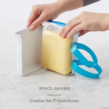 Freezer food block maker mold with teal handle, hands sealing food bag into white form