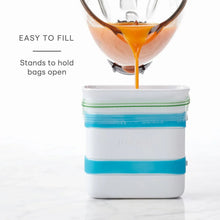 Freezer food block maker mold with blue band filling with orange mixture and green seal strip