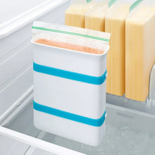 Freezer food block maker mold with blue bands and green seal, beside frozen food blocks