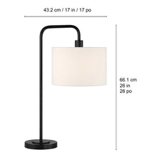 Black floor lamp with round base and drum-style white shade