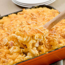 Crispy fried onions topping in a baking dish with wooden spoon