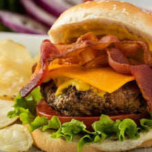 French's Classic yellow mustard spread on a burger bun with melted cheese and bacon