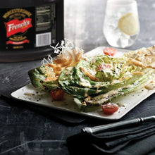 Worcestershire sauce bottle beside plated salad with creamy dressing