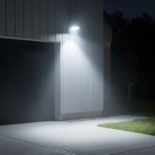 Solar area light illuminating driveway, rectangular LED lamp head with motion sensor