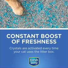 Cat paw over blue and gray litter crystals beside a constant freshness banner