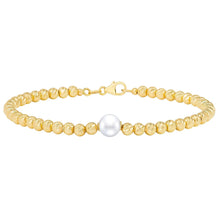 Freshwater pearl bracelet with gold clasp, round cream-gold beads and central white pearl