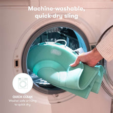 Teal mesh baby tub sling lifted from a washing machine