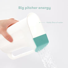 White baby rinse cup pouring water from the spout, teal grip section