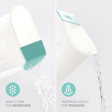 White rinse cup with teal rain shower head, pouring water in a fine spray