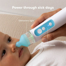 Electric nasal aspirator with display lights and clear chamber beside baby