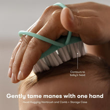 Teal head-hugging baby hairbrush and comb held in one hand