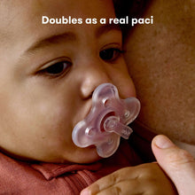 Baby using a pacifier-style medicine dispenser with clear syringe
