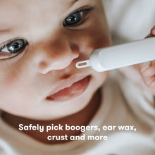 Baby face with grooming picker used on the nose area, white tool with teal detail